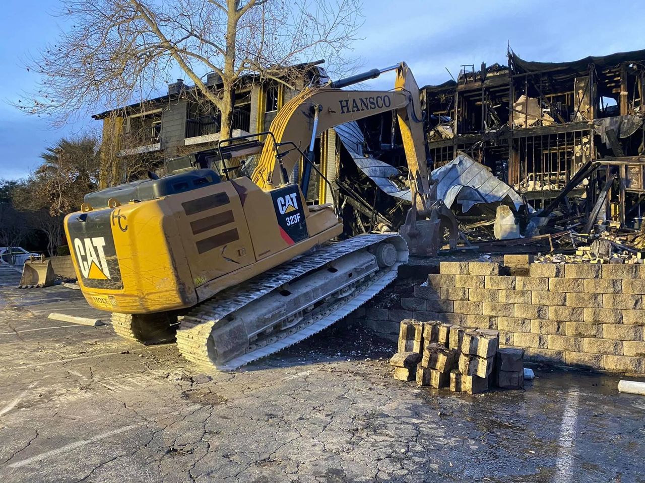 House demolition underway with an excavator on site