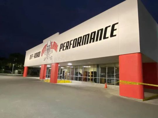 Off-Road Performance retail building at night, taped off with yellow caution tape.